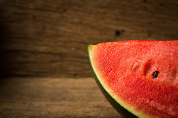 Fototapeta na wymiar slice of ripe watermelon on old wood