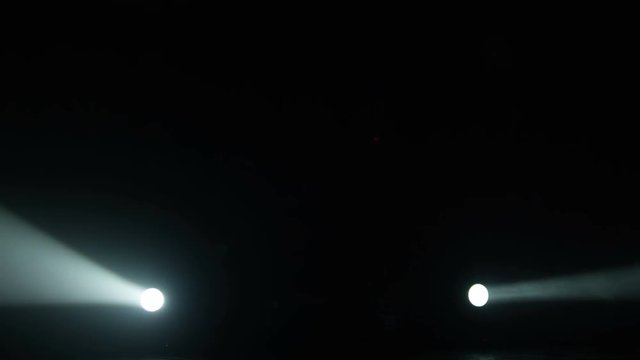 Realistic footage of stage light flashing rays spotlights through smoke. Great as a natural stage background for different projects!!!