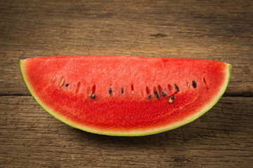 slice of ripe watermelon on old wood