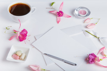 Creative flat lay photo of workspace desk with smartphone, coffee, pencil, flowers with copy space background. Flat lay.