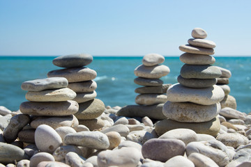 Fototapeta na wymiar Pyramid of pebbles on a sea beach.