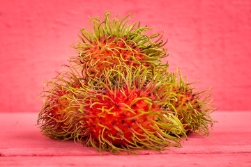 rambutan fruit on wood color pink