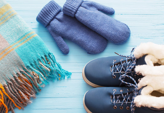 Blue Winter Shoes And Gloves On Blue Wooden Background