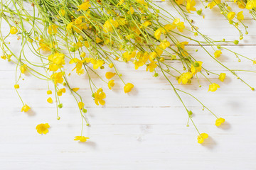 yellow flowers on wooden background