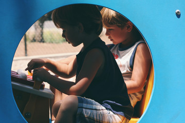 Two young boys play on playground