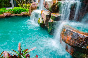 Beautiful Lush Waterfall in garden , green nature landscape background  greenery scene,