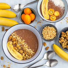 Trendy chocolate chia bowls with banana, mulberries and nuts