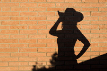 cowgirl silhouette on brick wall - country line dance