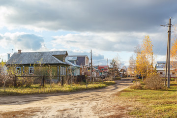 Fototapeta na wymiar Street with village houses in autumn