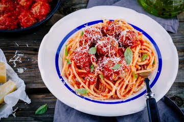 Spaghetti pasta with meatballs, tomato sauce and parmesan cheese