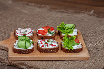 Sandwiches with cheese and vegetables. The concept of healthy eating and vegetarianism.