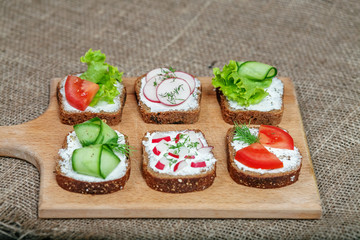 Sandwiches with cheese and vegetables and spices. Top view. The concept of healthy eating and vegetarianism.