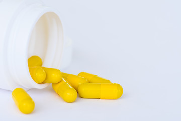 Closeup yellow pills, capsule on white background.  Medical and health care concept.