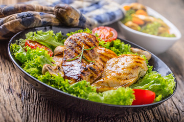 Grill Chicken Breast. Roasted and grill chicken breast with lettuce salad tomatoes and mushrooms