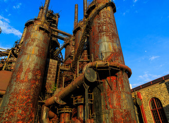 Industrial steel stacks rusted and colorful over time in Bethlehem Pa on a summer day.