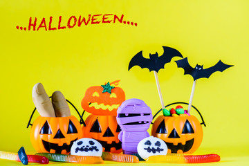 Halloween pumpkin with sweets candies including worms jelly and ghost marshmallow.