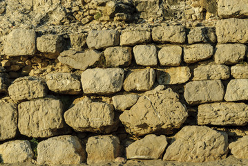 texture with ashlars of the Greek and Roman ruins of the archaeological place of Ampurias, on the brava coast in Spain.