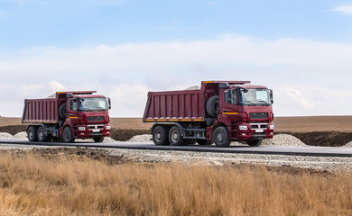 Dump trucks with gravel © Yuri Bizgaimer