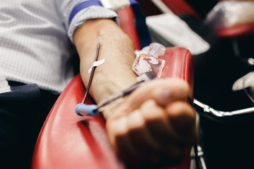 The donor blood donates blood in the clinic on a special chair. Blood sampling procedure for blood bank