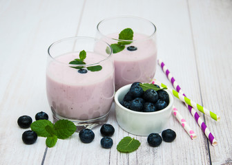 Glasses with blueberry yogurt on a table