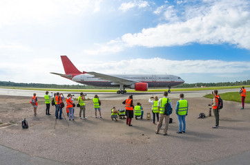 Airplane is ready for departure and take-off, a crowd of people sees off plane.