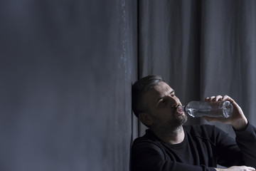 Unhappy man drinking alcohol