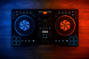 Black Modern DJ Set Turntable Mixer Equipment in Color Lights. 3d Rendering