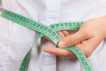 Weight Loss and Healthy Lifestyle Concept. Fitness Woman Measuring Her Waistline with Measure Tape