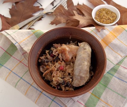 Delicious stewed cabbage with pork sausages, apples and cranberries