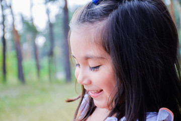 Latin kid laughing in the summer park. 