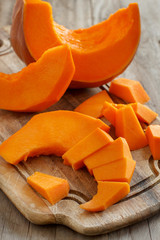 Pumpkin slices on a wooden background