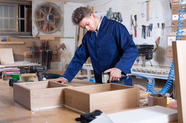working man practising his skills in making drawer at workshop