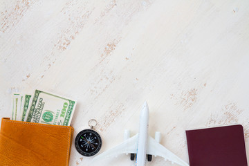 travel concept. money for travel in leather wallet with compass and aircraft toy