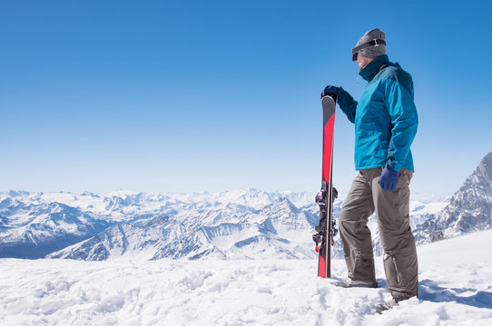 Man with ski on mountain top