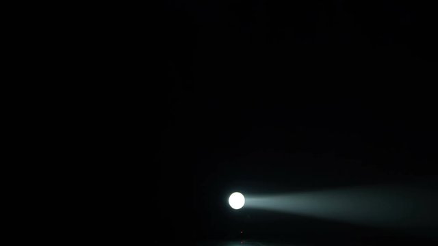 Realistic footage of stage light flashing rays spotlights through smoke. Great as a natural stage background for different projects!!!