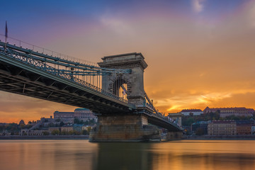 Naklejka premium Budapest, Hungary - The beautiful Szechenyi Chain Bridge and Buda Castle Royal Palace with amazing colorful sunset and sky