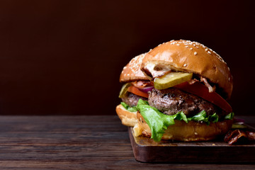 Burger on wooden background with copy space