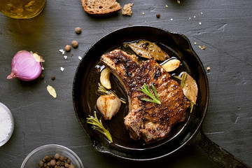 Pork steak in frying pan, top view