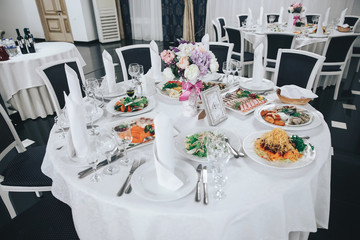 the restaurant, set tables with white table cloths