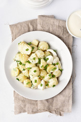 Potato salad with eggs and green onion