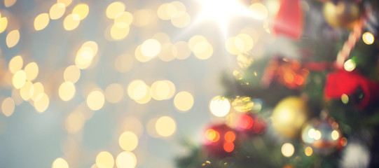 Obraz na płótnie Canvas blurred christmas tree decorated with balls