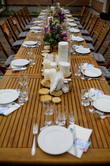 Dinner table served with candles and violet lilac