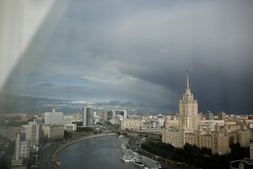 Dark clouds hang over grey Moscow cityscape