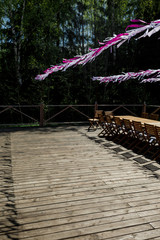 White and violet ribbons decorate wooden porch