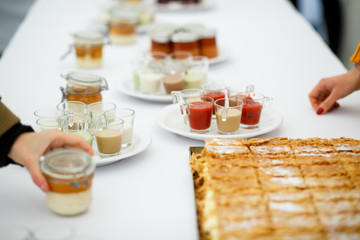 Cups with differed sauces served on white plate