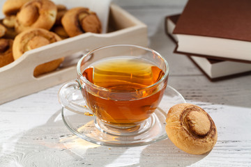 Cup of tea with cakes on wooden tray