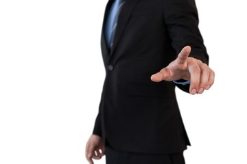 Mid section of businessman in suit using invisible interface