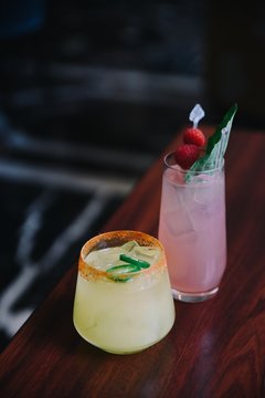 Glasses of spicy margarita and gin and raspberry cocktails