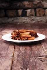 Fragrant star anise and cinnamon on wooden table.