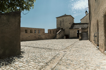 A old courtyard of a medieval castle in the city of Corte on the isle of Corsica in summertime